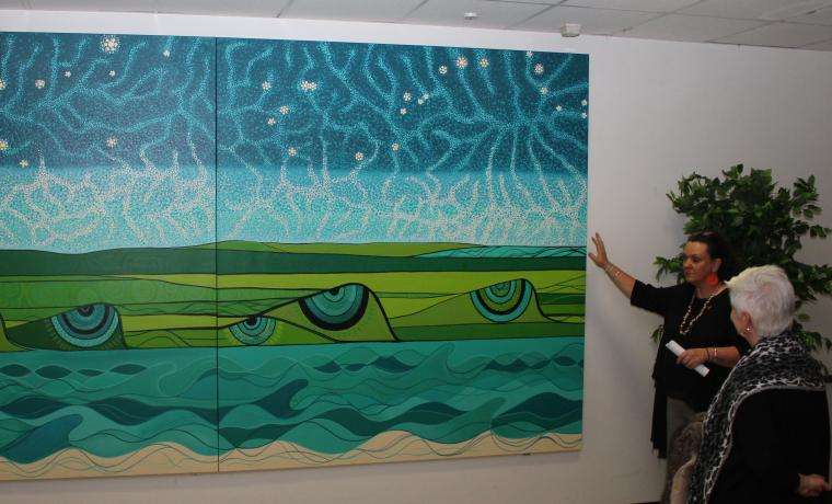 Artist Aunty Patrice Mahoney OAM explains her artwork’s representation of the sky and the land of the Bass Coast, watched by BCH CEO Jan Child. This artwork is on display in Grabham Wing, near Dialysis.