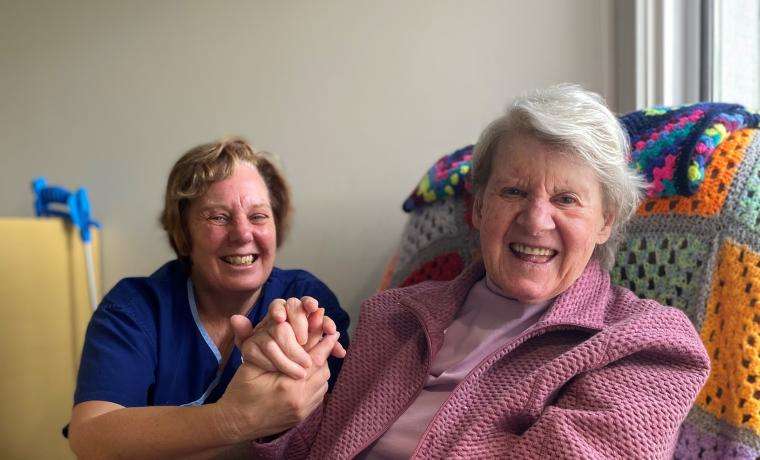 Personal Care Worker Karen McBride enjoys a moment of joy with resident Pat Argent at Griffiths  Point Lodge, San Remo.