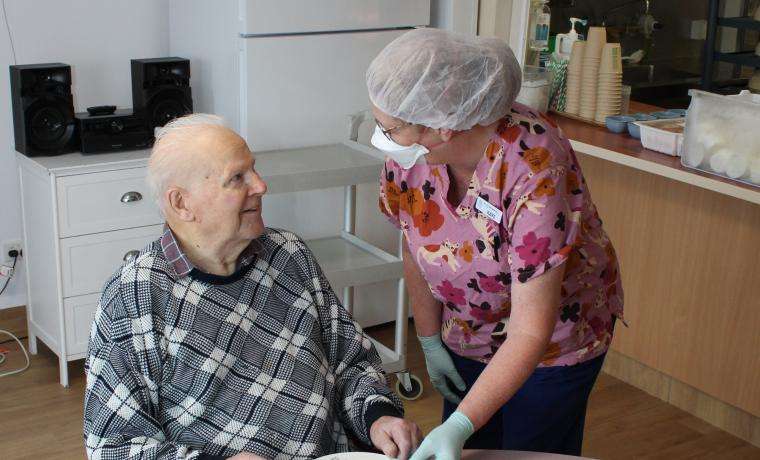 Resident Eddie Harmer receives a nutritious lunch from Food Service Assistant Kaye Henshall at Kirrak House, Wonthaggi. 