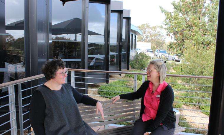 Alison Treloar, left, post-treatment, discusses her breast cancer journey with McGrath Breast Care Nurse Taryn Robinson outside the L. Rigby Cancer Centre at Wonthaggi Hospital.