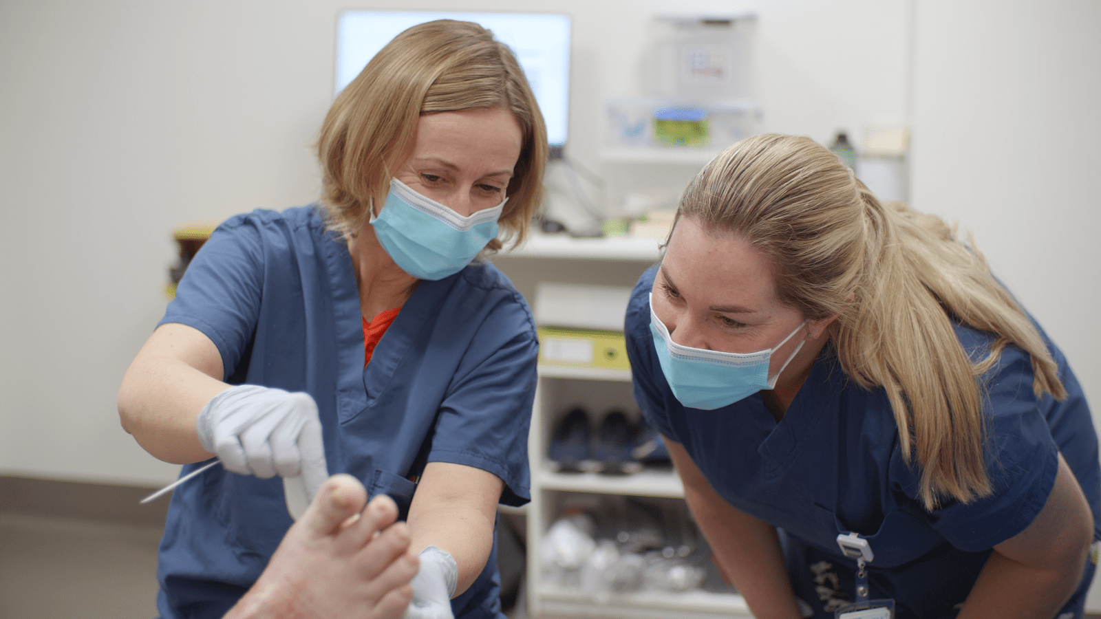 Podiatrist and a nurse working with a consumer