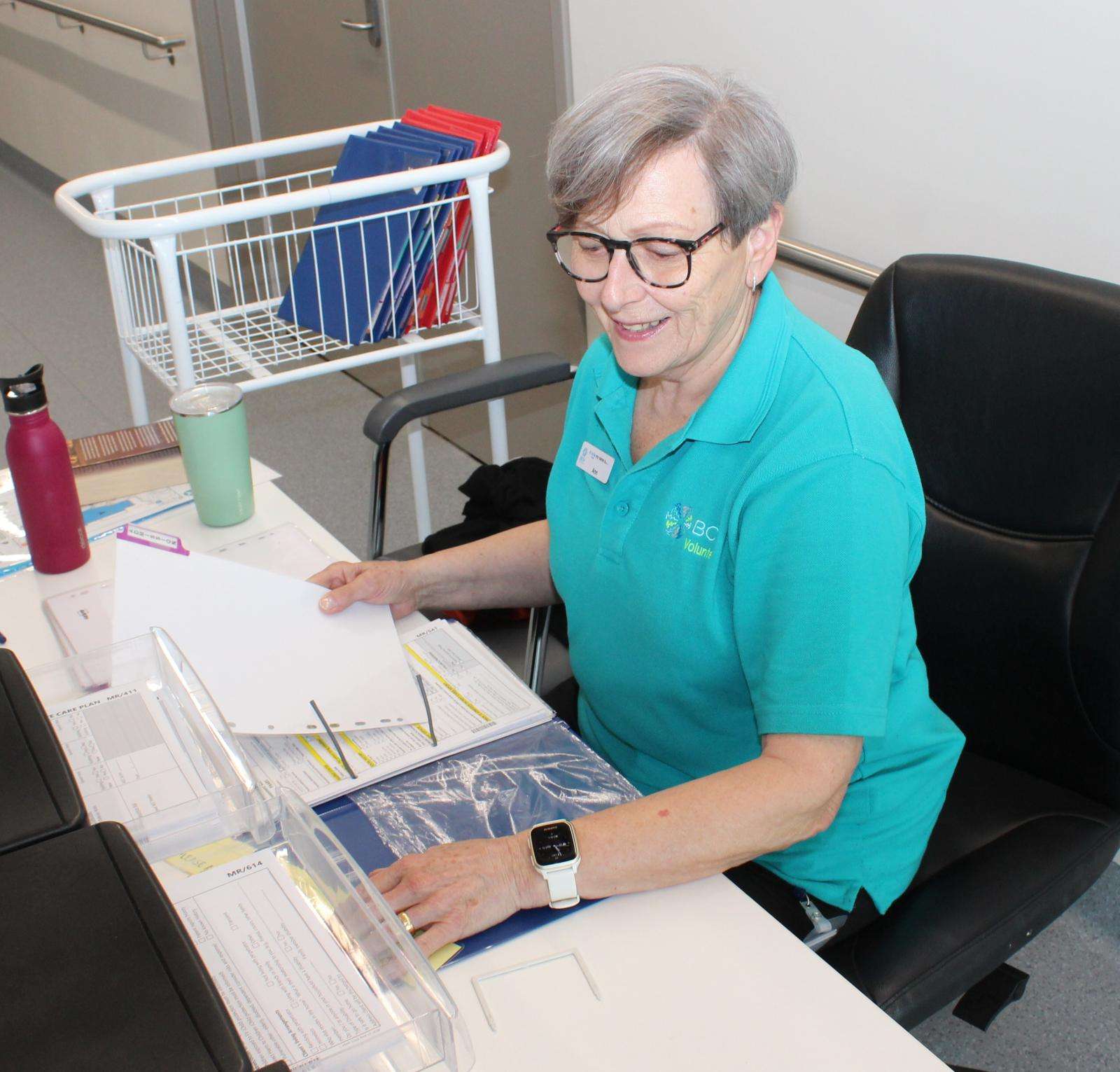 Volunteer Anna Booth undertakes administration duties.